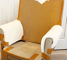 a chair that is made out of cardboard and some tape on the back of it