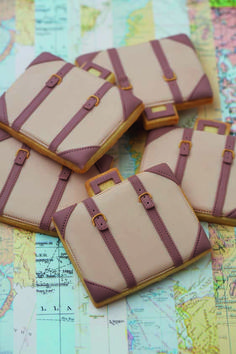 four luggage cookies sitting on top of a map