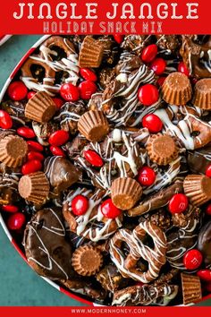 a holiday snack mix in a red bowl with chocolate, candy and candies on top