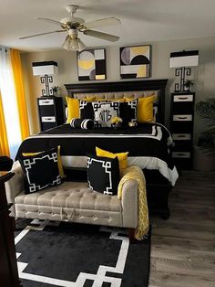 a black and white bedroom with yellow accents