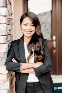 a woman standing in front of a door with her arms crossed