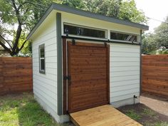 a small shed with a wooden step leading up to it