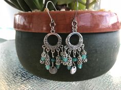 This beautiful pair of boho style dangle earrings is made with aqua Czech glass beads and silver daisy flower spacer beads. Boho earrings hang 2 inches from stainless steel earwire for the sensitive ears. Nickel-free Bohemian Beaded Earrings For Crafting, Bohemian Dangle Earrings For Jewelry Making, Bohemian Earrings With Dangling Charms, Bohemian Hoop Earrings With Dangling Charms, Silver Dangling Charms Earrings For Festival, Bohemian Style Crystal Drop Earrings With Dangling Beads, Bohemian Chandelier Earrings With Dangling Beads, Silver Festival Earrings With Dangling Charms, Bohemian Dangling Beads Drop Earrings