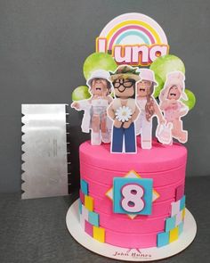 a birthday cake with an image of people on top and the number eight in front