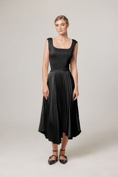 Elevate your style with the Naomi Ballerina Maxi Length Pleated Skirt. The handkerchief hems add a graceful sway to your steps, enhanced by the luxurious Satin Plissé. A soft elastic waistband guarantees a secure and comfortable fit all day long, making this skirt a delightful combination of feminine style and ease. Pair it with a cotton print tee for a casual look, or opt for our plissé tank for a more chic and feminine ensemble. Skirt Overall Length: 31" 100% Polyester - Satin Weave Easy Garme