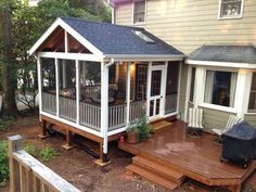 a small house with a deck and covered patio