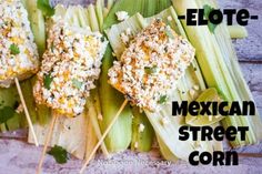 mexican street corn is served on skewers with feta cheese and cilantro