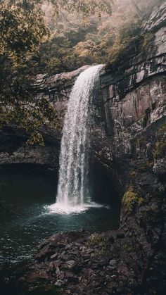 a black and white photo of a waterfall