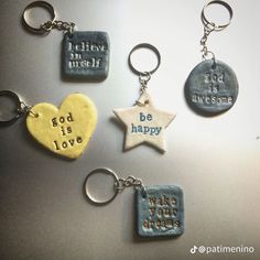 four different key chains with words on them