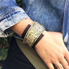 a close up of a person's wrist wearing a bracelet with flowers on it