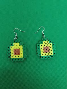 a pair of earrings made out of perler beads