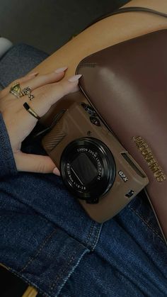 a person holding a camera in their lap