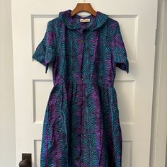 Nwt Elisamama Designer Midi Shirtdress, Purple And Blue/Green, Size M New With Tags. Never Been Worn. No Flaws. Smoke Free Home. Selling For My Mom As She Bought But No Longer Has An Occasion To Wear. Happy To Answer Any Questions! Purple Collared Summer Dress, Purple Fitted Collared Dress, Fitted Purple Collared Dress, Blue Short Sleeve Dress For Daywear, Blue Short Sleeve Shirt Dress For Daywear, Blue Collared Cotton Midi Dress, Purple Short Sleeve Dress For Daywear, Blue Collared Casual Dress, Blue Collared Dress For Dress Down Occasions