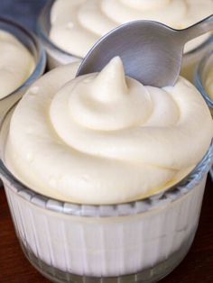 three desserts with white frosting and a spoon