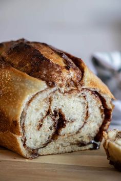 a cinnamon roll cut in half on a cutting board