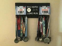 two medals are hanging on the wall in front of a plaque that reads, sole mates for the long run