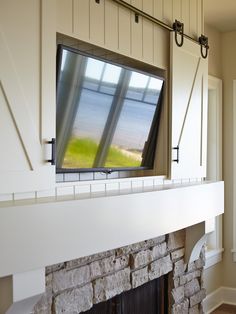 a tv mounted to the side of a fireplace