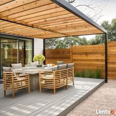 an outdoor dining area with wooden decking and patio furniture, surrounded by greenery