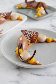 two plates with desserts on them sitting on a counter top next to each other