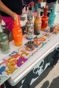 a table topped with lots of bottles of alcohol