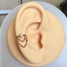 a close up of a cake with a ring on it's ear and chain