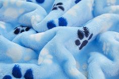 a blue teddy bear with paw prints on it