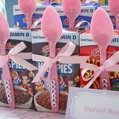 pink candy lollipops are on display in front of cereal boxes