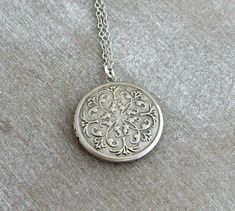 Round shaped locket with a Moroccan inspired design on the front. The locket is antique silver plated style and has a plain back Locket is 32 mm (approx 1 1/4 inches) Chain is antique silver plated and comes in a variety of lengths To see our full range of lockets please click here https://www.etsy.com/uk/shop/beadishdelight?ref=seller-platform-mcnav&section_id=26380425 Any questions, please ask Thank you for visiting Beadish Delight Silver Pendant Locket Necklace With Vintage Charm, Ornate Antique Silver Pendant Locket Necklace, Antique Silver Medallion Locket Necklace With Vintage Charm, Nickel Free Silver Medallion Locket Necklace, Silver Filigree Medallion Locket Necklace, Silver Medallion Locket Necklace With Vintage Charm, Nickel-free Silver Medallion Locket Necklace, Antique Silver Locket Necklace Nickel Free, Silver Medallion Locket Necklace