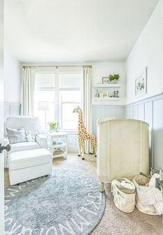 a baby's room with a giraffe in the window and toys on the floor