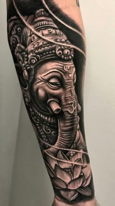 an elephant with a crown on its head is shown in this black and grey tattoo