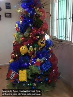 the christmas tree is decorated with legos and other things in blue, red and green