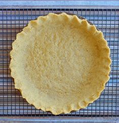 an uncooked pie sitting on top of a cooling rack