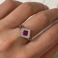 This Cocktail Ring Holds 4 Princess Cut Pink Rubies At The Center And 3 Tiny Rubies On Each Side Of The Shank. The Halo Is Set With Tiny Diamonds. This Unique Design Is Crafted In 14k White Gold With Ring Size 7. The Total Carat Weight Of Rubies Is 0.35cts And Diamonds Is 0.15cts. Comes With A Presentable Gift Box. Id: 031760 Luxury Pink Sapphire Ring With Pave Setting, Luxury White Gold Ruby Ring With Pave Setting, Formal Pink Sapphire Ring With Pave Setting, Anniversary Pink Sapphire Rings With Pave Setting, Fine Jewelry Ruby Ring With Pave Setting For Anniversary, Wedding Ring With Pink Sapphire And Pave Setting, Platinum Ruby Ring With Diamond Accents, Platinum Ruby Ring With Diamond Cut, Formal White Gold Ruby Ring With Pave Setting