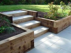 a garden area with steps and plants in it