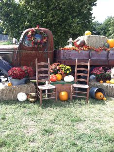 an old truck with hay bales and pumpkins