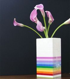 a vase filled with pink flowers on top of a wooden table