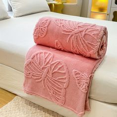 two towels folded on top of a bed