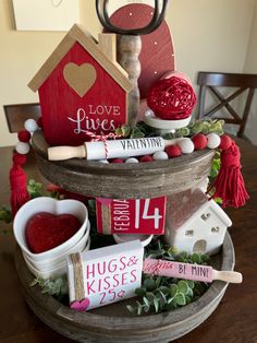 a table topped with lots of different types of crafts and decorations on top of a wooden tray