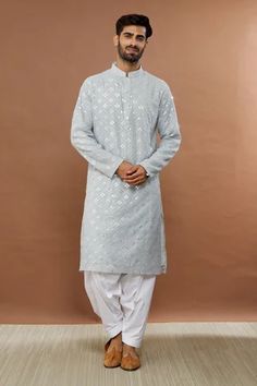 Light grey kurta with mirror embroidery and mandarin collar. Paired with white patiala.
Component: 2
Pattern: Embroidered
Type Of Work: Mirror
Neckline: Mandarin
Sleeve Type: Full
Fabric: Cotton Blend
Color: Grey
Other Details: 
Mirror work
Occasion: Mehendi and Puja - Aza Fashions Ceremonial Straight Kurta With Mirror Work, White Chanderi Sherwani With Mirror Work, Diwali Kurta With Mirror Work For Puja, White Chanderi Sherwani For Puja, Ceremonial Straight Kurta With Chikankari Embroidery, Ceremonial Chikankari Embroidery Kurta For Navratri, Navratri Ceremonial Kurta With Chikankari Embroidery, Traditional Drape Kurta With Chikankari For Puja, Traditional Chikankari Kurta For Puja