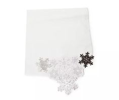 a white napkin with snowflakes on it and a black snowflake in the middle