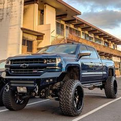 a large blue truck parked in a parking lot