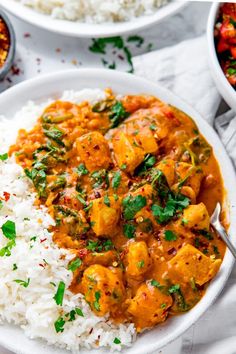 two bowls filled with rice and chicken curry