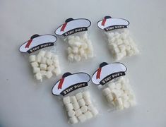 six small white marshmallows in plastic bags with stickers that say stay out