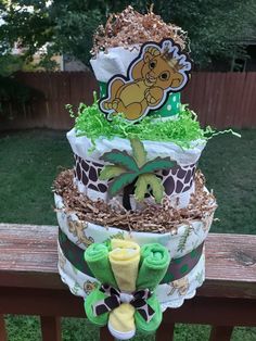 a three tiered diaper cake made to look like a giraffe baby shower