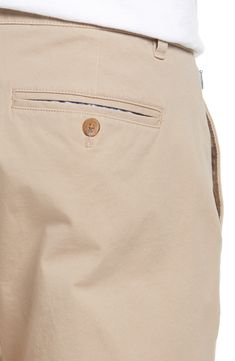 Made from soft four-way-stretch fabric, these slim-tailored chinos feature a curved waistband and a zip pocket for secure storage while you're on the move. 14" leg opening; 10 1/2" front rise; 15 1/2" back rise (size 32x30) Zip fly with button closure Side slant pockets; side zip pocket; back button-welt pockets Moisture-wicking, wrinkle-resistant fabric engineered for dryness and comfort 92% cotton, 8% spandex Machine wash, tumble dry Imported Men's Clothing Chinos With Pockets And 5-inch Inseam, Business Casual Chinos With Hip Pockets, Beige Chinos For Business Casual With Pockets, Beige Business Casual Chinos With Pockets, Curved Waistband, Welt Pockets, Welt Pocket, Side Zip, Men's Clothing