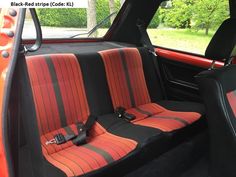 the interior of a car with red and black stripes on it's seat covers