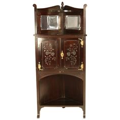 an old fashioned wooden cabinet with glass doors