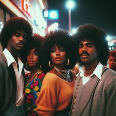 four people standing in front of a store at night with one woman wearing an afro hairstyle