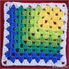 a crocheted square with different colors on it