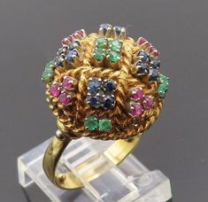 18K GOLD - Vintage Emerald Ruby & Sapphire Twist Dome Cocktail Ring Sz 5 - GR005  Jewelry Type:         Ring   Metal Type:            18K Gold   Metal Size:             5 Finger  Stone Type:            Emerald Ruby & Sapphire   Condition:              N/A  Jewelry Weight:     9.8 Grams  PLEASE NOTE: THIS ITEM IS PRE-OWNED. ALTHOUGH MOST ITEMS ARE IN VERY GOOD CONDITION, SOME MAY NEED CLEANING AND/OR MINOR REPAIRS. WE MAKE A VERY STRONG EFFORT TO UPLOAD CLEAR PICTURES. PLEASE INSPECT ALL PICTURES AND ASK ALL QUESTIONS YOU MAY HAVE PRIOR TO MAKING A PURCHASE. NOT ALL STONES ARE GENUINE, SOME ARE ENHANCED OR CREATED. Antique Gold Multi-stone Emerald Ring, Antique Gold Emerald Ring With Multi-stone, Antique Green Multi-stone Ring, Gold Multi-stone Round Emerald Ring, Gold Multi-stone Emerald Ring, Antique Jewelry Rings, Ruby Sapphire, Cocktail Rings, Vintage Watches